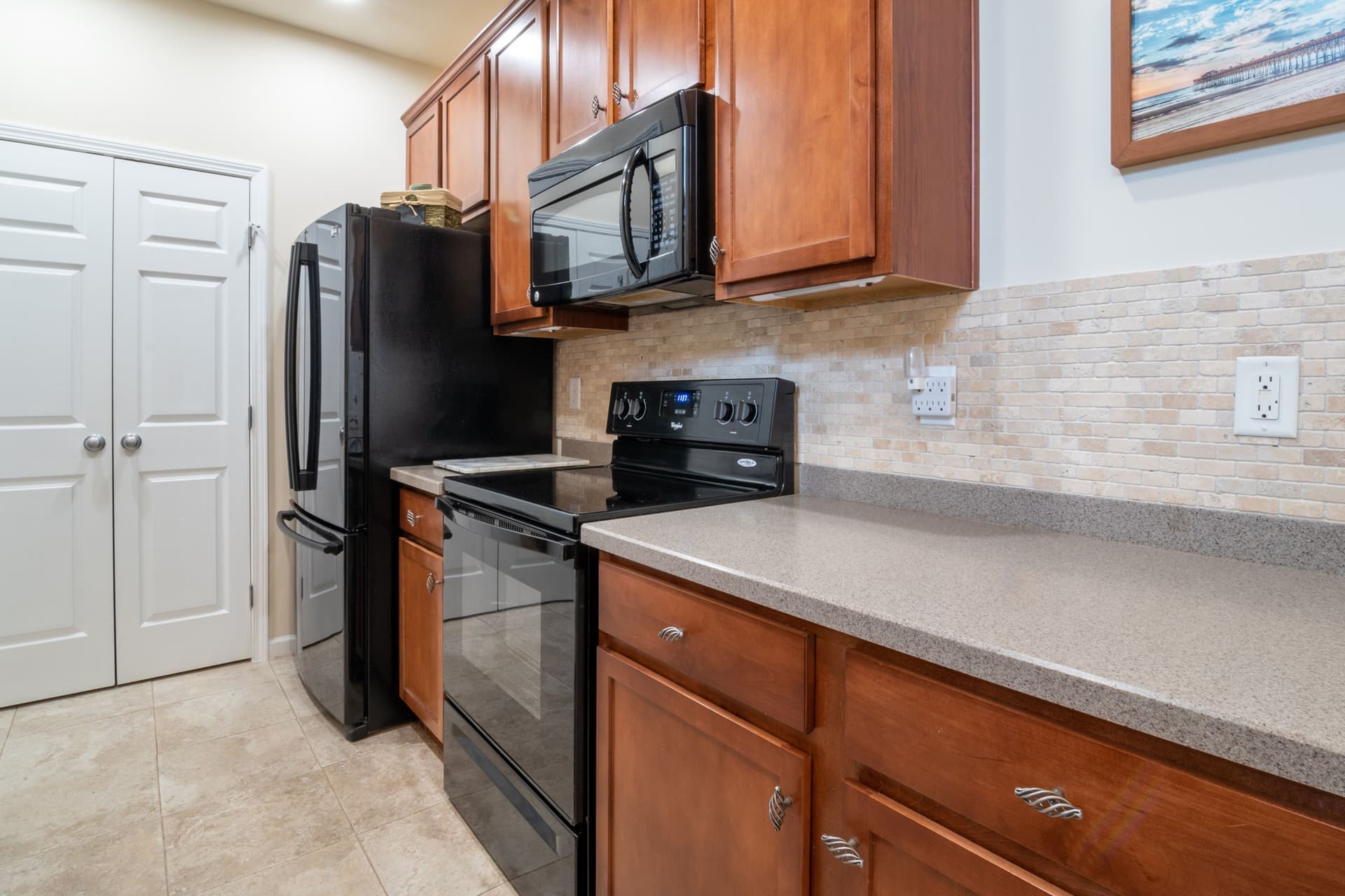A modern kitchen with stainless steel appliances and wooden cabinets (illustrative photo)