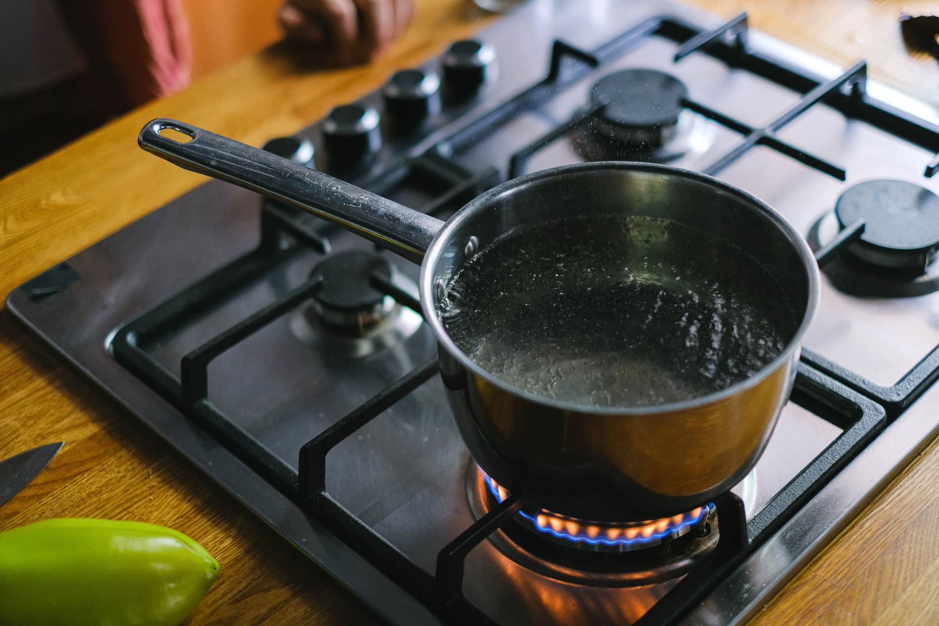 Water boiling in a stainless steel pot on a stove, one of the ways feeding items are sanitized (illustrative photo)